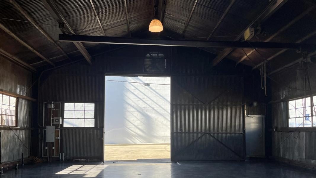 Effortlessly access the rear of the building through any of the three sliding doors, each spanning a generous 12 feet in width.